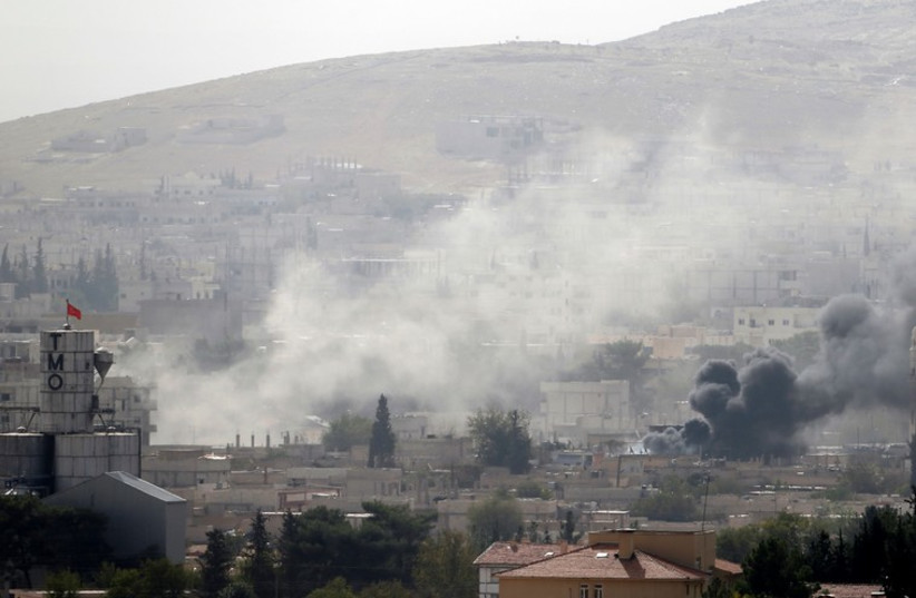 Smoke rises from the Syrian town of Kobani, as seen from near the Mursitpinar border crossing on the Turkish-Syrian border October 10, 2014.  (photo credit: REUTERS)