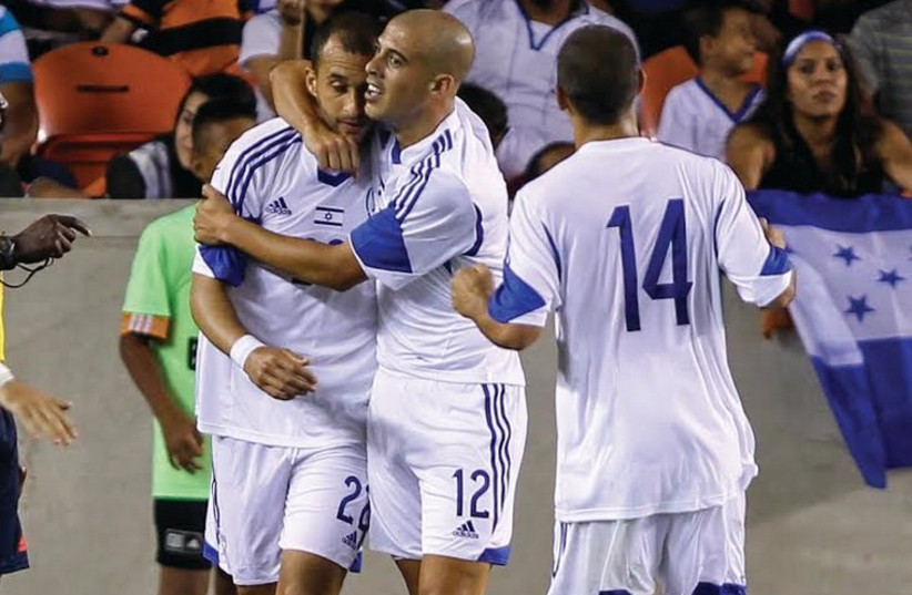 Israel’s goalscorers Omer Damari (left) and Tal Ben-Haim celebrate on Friday night after leading the blue-and-white to a 2-1 victory over Cyprus in Nicosia. (photo credit: REUTERS)