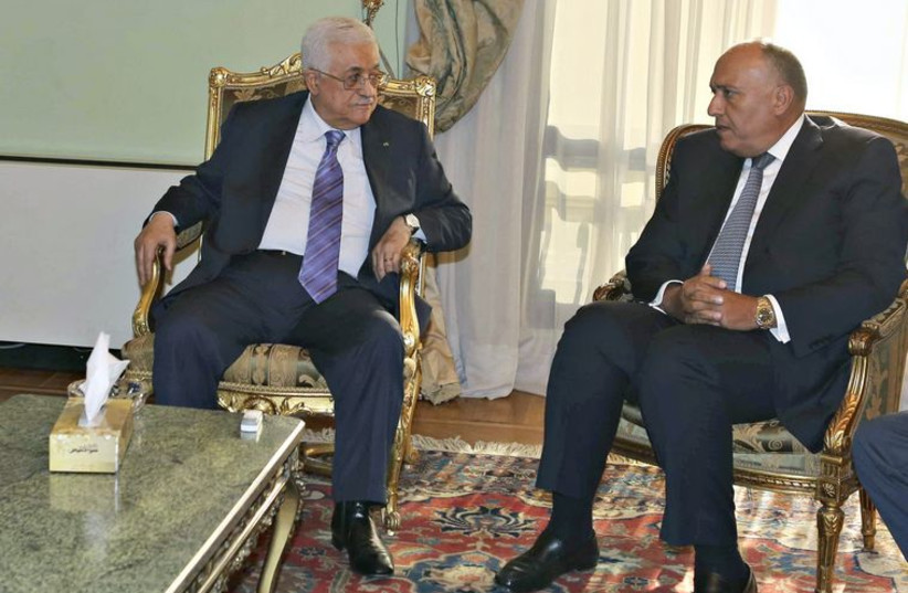 Palestinian Authority President Mahmoud Abbas meets Egyptian Foreign Minister Sameh Shukri and Arab League Secretary General Nabil al-Araby ahead of Gaza aid conference. (photo credit: REUTERS)