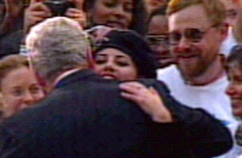 Monica Lewinsky hugs President Clinton in a file photo.  (photo credit: REUTERS)