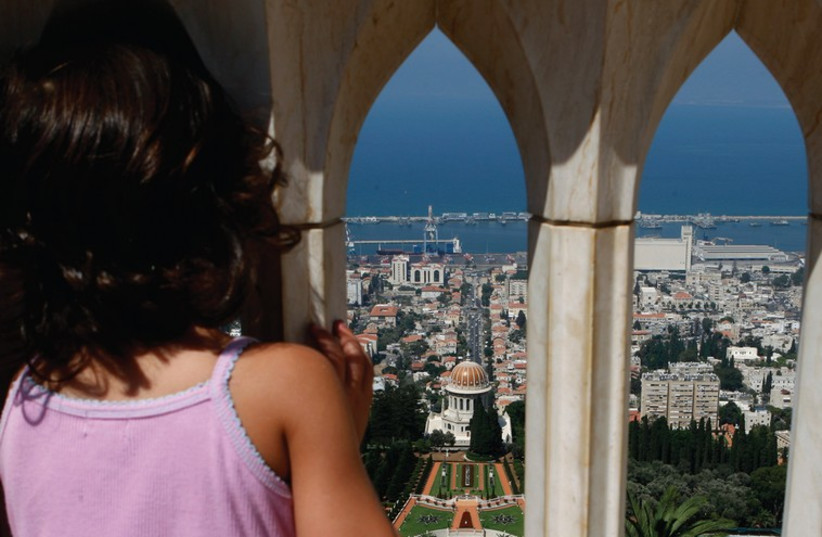 A young girl looks down over the city of Haifa. (photo credit: REUTERS)