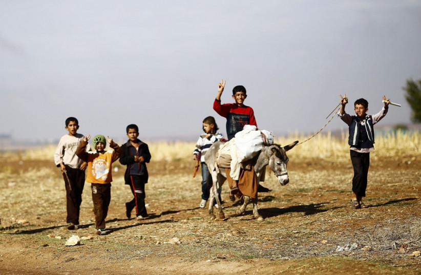 Christian refugees flee ISIS (photo credit: REUTERS)