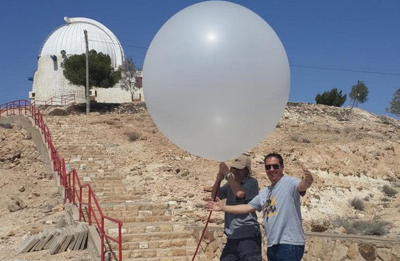 Yoav Yair (right) and a technician launch a balloon two weeks ago in Mitzpe Ramon. (photo credit: COURTESY PROF. YOAV YAIR)