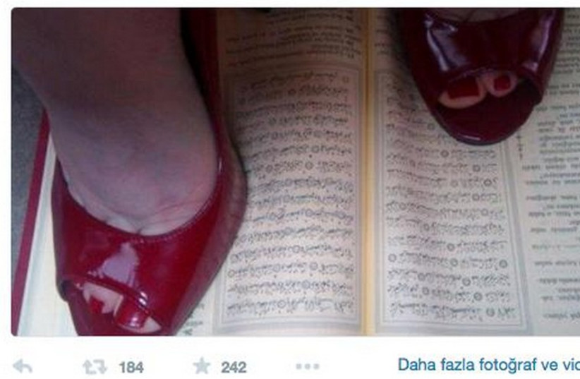 Turkish woman tweeting picture standing on Quran (photo credit: TWITTER)
