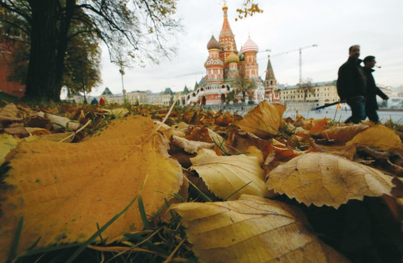 People walk near St. Basil’s Cathedral in Red Square in central Moscow last week. (photo credit: REUTERS)