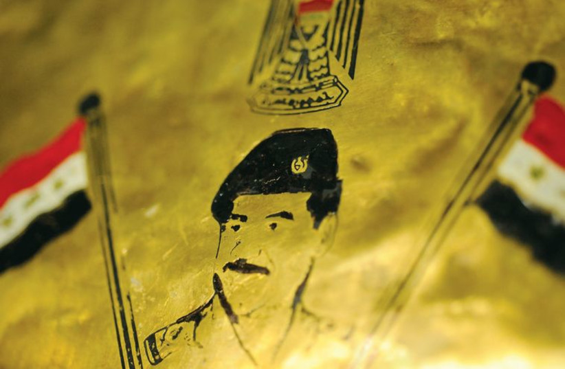 An image of former Iraqi leader Saddam Hussein printed on copper. (photo credit: REUTERS)