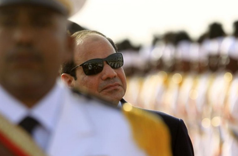 Egypt's President Abdel Fattah al-Sisi inspects the guard of honor upon arriving at Khartoum International Airport in Khartoum (photo credit: REUTERS)