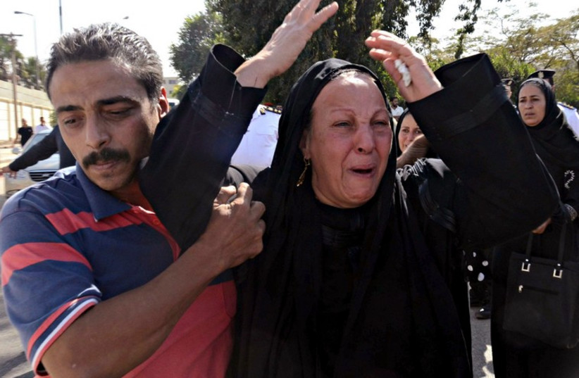 Egyptian woman mourns at funeral of Sinai terror attack victim (photo credit: REUTERS)