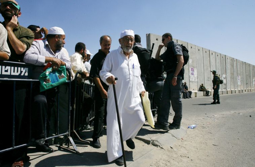 Israeli border policemen control Palestinian worshippers at Qalandiya check-point at the outskirts of Jerusalem (photo credit: REUTERS)