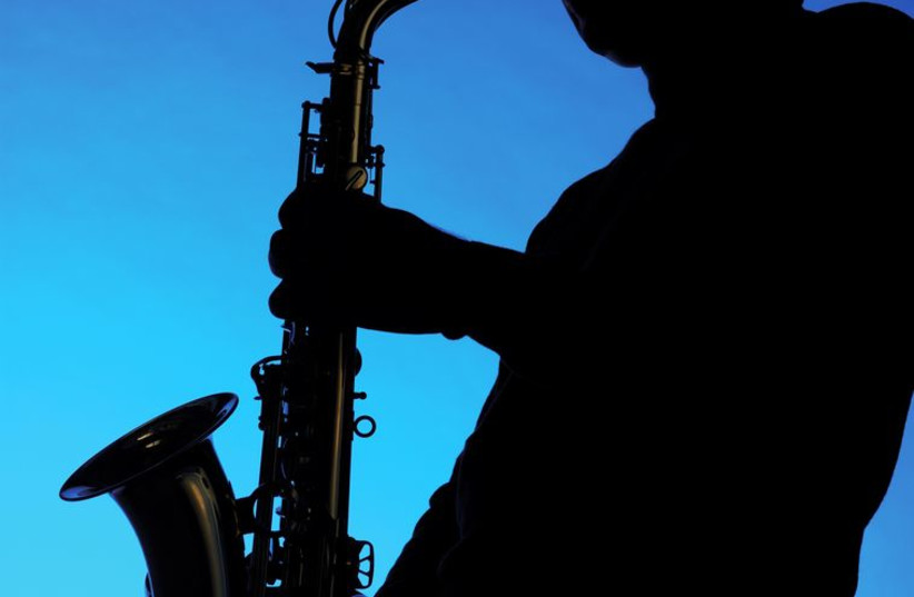Silhouette of a musician playing the saxophone (photo credit: INGIMAGE)