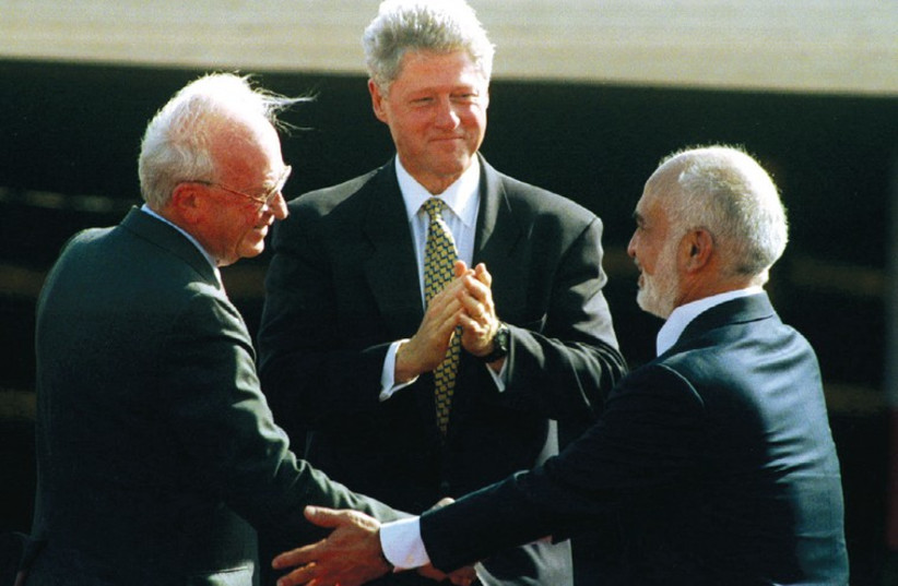 Prime ministers Yitzhak Rabin and US president Bill Clinton congratulate Jordan’s King Hussein after his speech at the Israeli-Jordanian peace treaty signing ceremony on October 26, 1994. (photo credit: REUTERS)