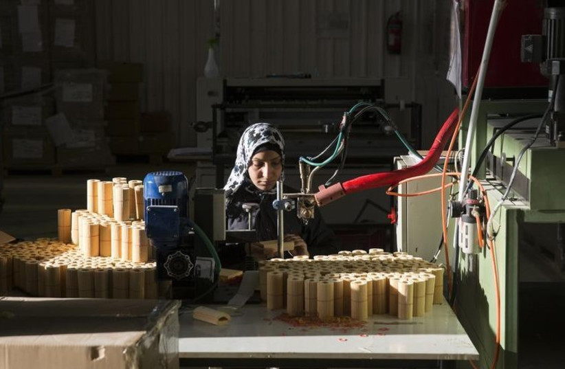 A Jordanian laborer works at a car filter plant in the Jordan Gateway Industrial Park, a free trade zone straddling the Israel-Jordan border (photo credit: REUTERS)