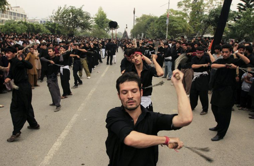 Pakistani Shi'ite Muslim men flagellate themselves during a Muharram procession in Islamabad, Pakistan, November 3, 2014. (photo credit: REUTERS)