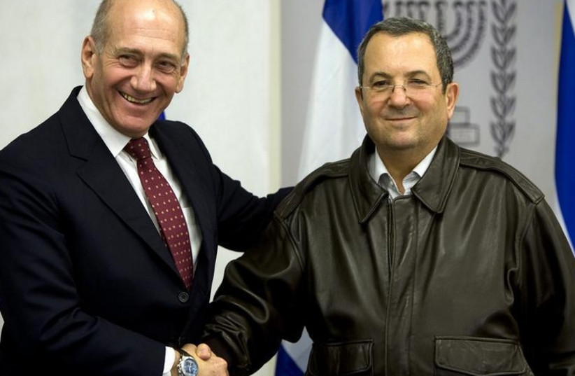 Former prime minister Ehud Olmert (L) shakes hands with his defense minister, Ehud Barak (photo credit: REUTERS)