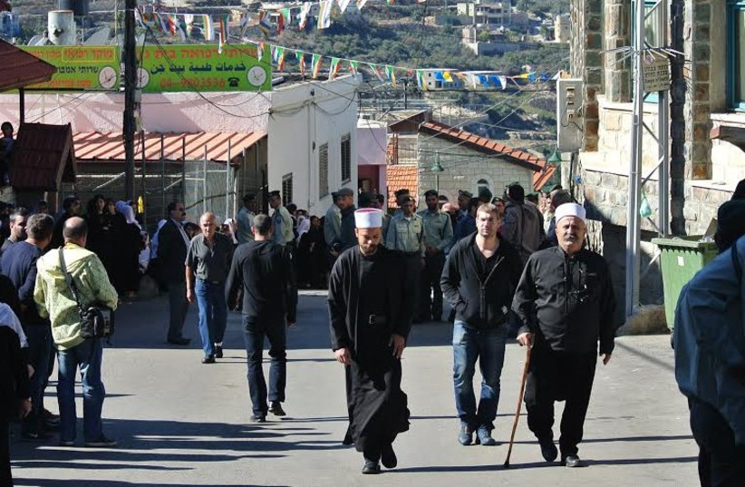 BEIT JANN residents arrive for the funeral of Border Police officer Jidan Assad. (photo credit: SETH J. FRANTZMAN)