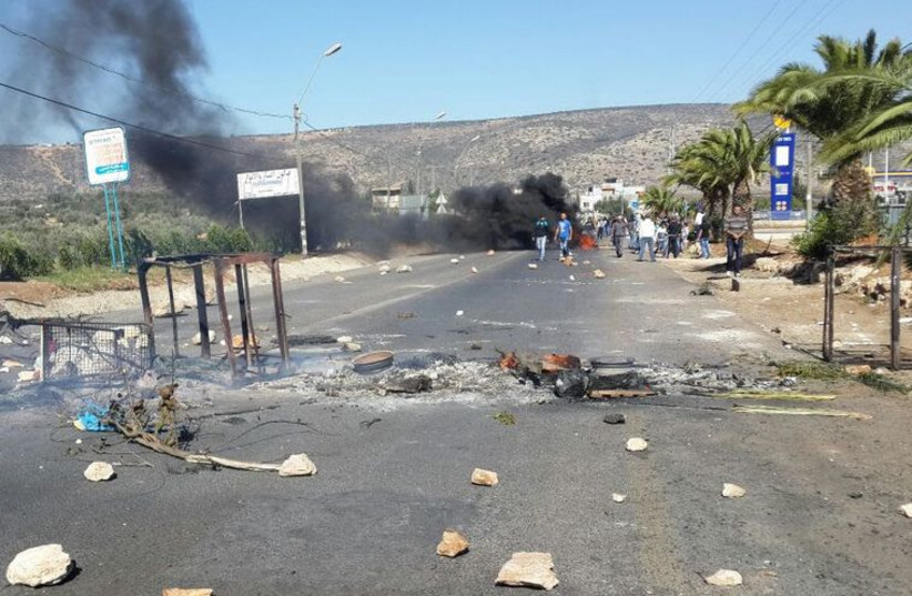 Youths set fire to tires throw stones at entrance to Kafr Kana Sunday (photo credit: BOKRA.NET)
