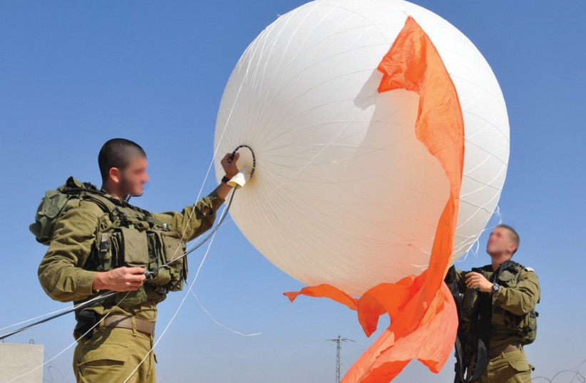IDF SOLDIERS display a portable surveillance balloon meant to improve the visual intelligence capabilities of field units. (photo credit: IDF SPOKESMAN’S UNIT)