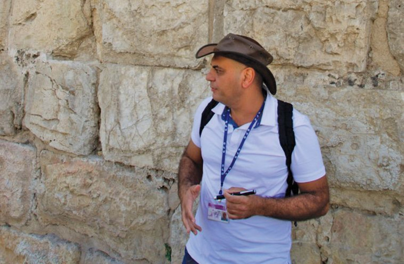 Author and journalist Shlomo Cesana explores the stories behind some of the capital’s unique stone marks. (photo credit: Courtesy)