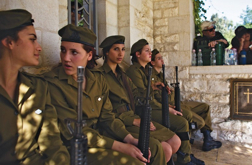 Soldiers attend a Remembrance Day ceremony at the British Commonwealth cemetery in Ramle last Sunday. (photo credit: REUTERS)