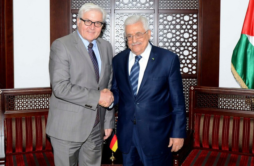 PA President Mahmoud Abbas (R) shakes hands with Germany's Foreign Minister Frank-Walter Steinmeier in Ramallah,  November 15, 2014 (photo credit: REUTERS/OSAMA FALAH/PALESTINIAN PRESIDENT OFFICE ()