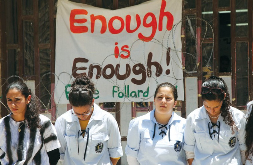 Young women in the Bnei Akiva youth movement wear mock prison outfits to protest the imprisonment of Jonathan Pollard (photo credit: MARC ISRAEL SELLEM)
