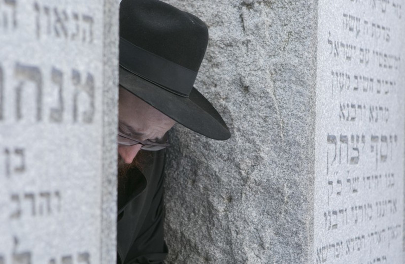 A Chabad-Lubavitch rabbi reflects at the gravesite of the Lubavitcher Rebbe, Rabbi Menachem M. Schneerson (photo credit: ADAM BEN COHEN / CHABAD.ORG)