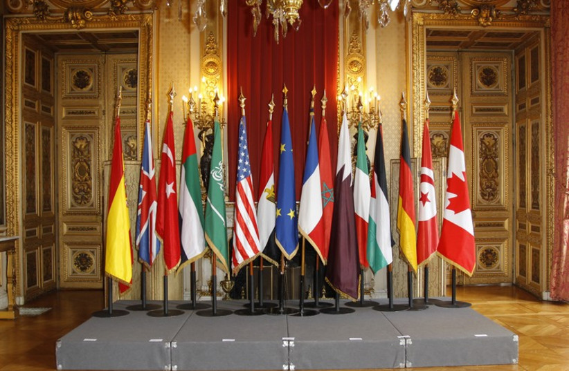 Flags are seen of major international powers ahead of a meeting in Paris (photo credit: REUTERS)