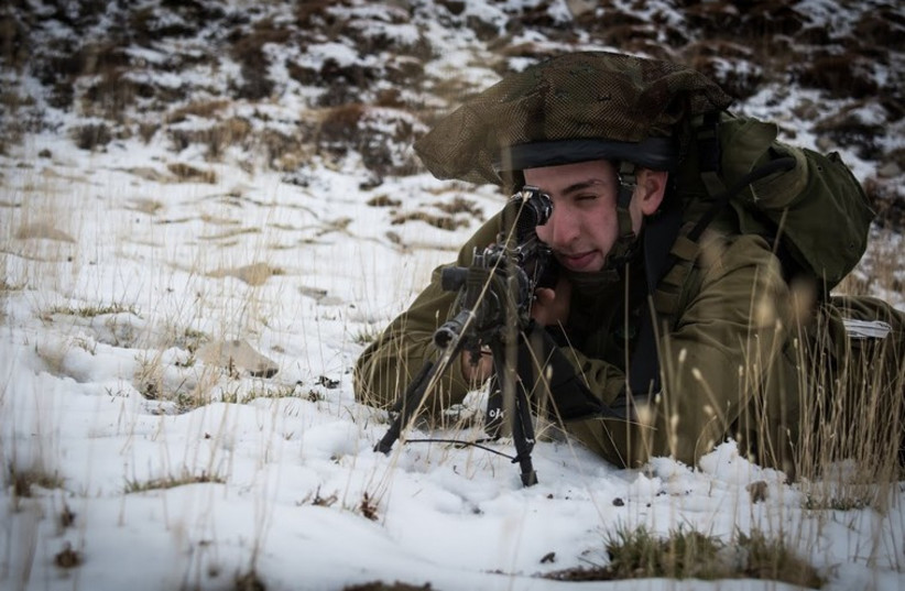 A soldier in the IDF's 890th Paratrooper Battalion trains in Israel's first snow of the winter season. (photo credit: IDF SPOKESPERSON'S UNIT)