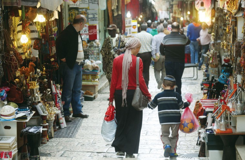 A Jewish woman and her child walk through Jerusalem's Old City (photo credit: MARC ISRAEL SELLEM/THE JERUSALEM POST)