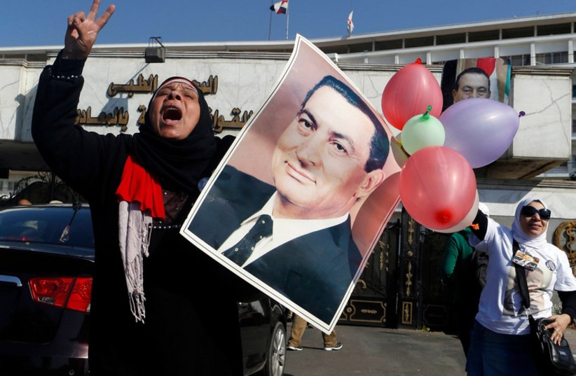 Supporters of former Egyptian President Hosni Mubarak celebrate after hearing the verdict of his trial in Cairo November 29 (photo credit: REUTERS)