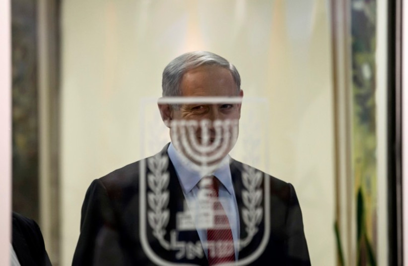 Prime Minister Benjamin Netanyahu smiles before delivering joint statements to the media in Jerusalem December 1 (photo credit: REUTERS)