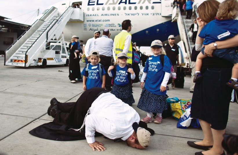 A new immigrant at Ben-Gurion airport kisses the tarmac as he makes aliya (photo credit: REUTERS)