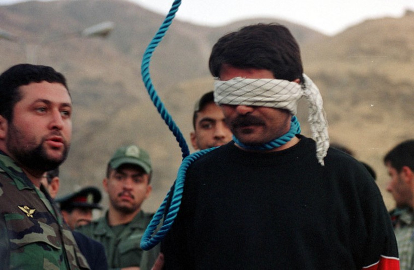 Iranian Judiciary officials prepare to hang convicted murderer Hashem (photo credit: REUTERS)
