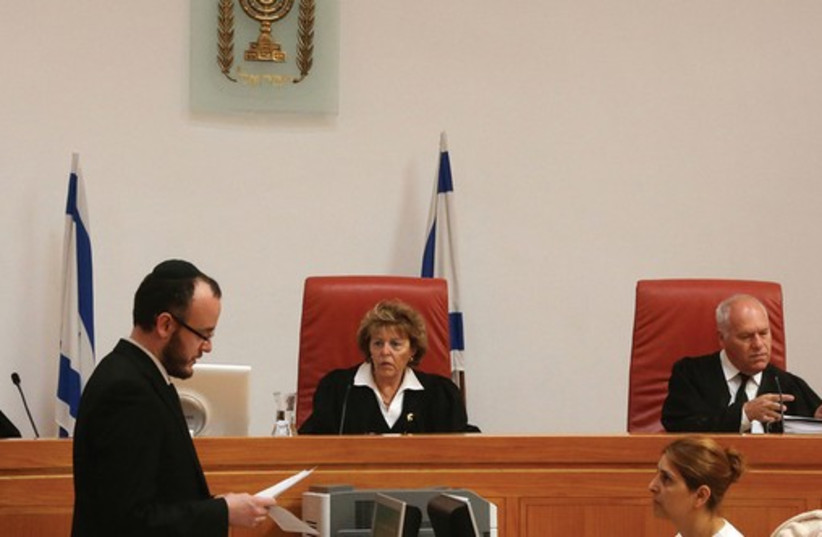 ISRAEL SUPREME Court justices at a hearing. The court has invalidated the infiltrators law. (photo credit: MARC ISRAEL SELLEM/THE JERUSALEM POST)