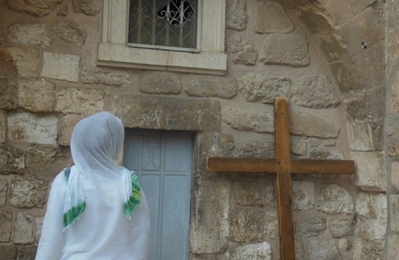 A Christian woman outside the Church of the Holy Sepulchre in Jerusalem (photo credit: ARIEL COHEN)