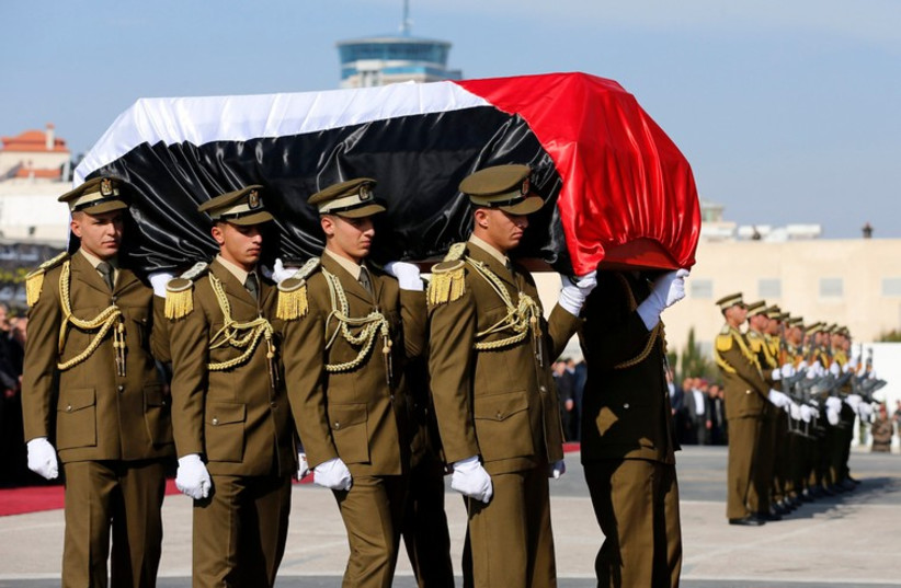 Palestinian honor guards carry the coffin of Palestinian minister Ziad Abu Ein during his funeral in the West Bank city of Ramallah (photo credit: REUTERS)