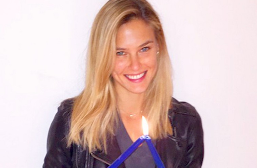 Bar Refaeli with two blue candles in support of autism awareness (photo credit: Courtesy)