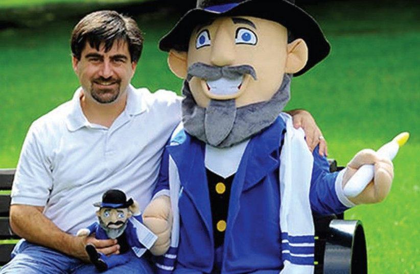 AMERICAN TOYMAKER Neal Hoffman poses with a prototype of his Mensch on a Bench. (photo credit: PR)