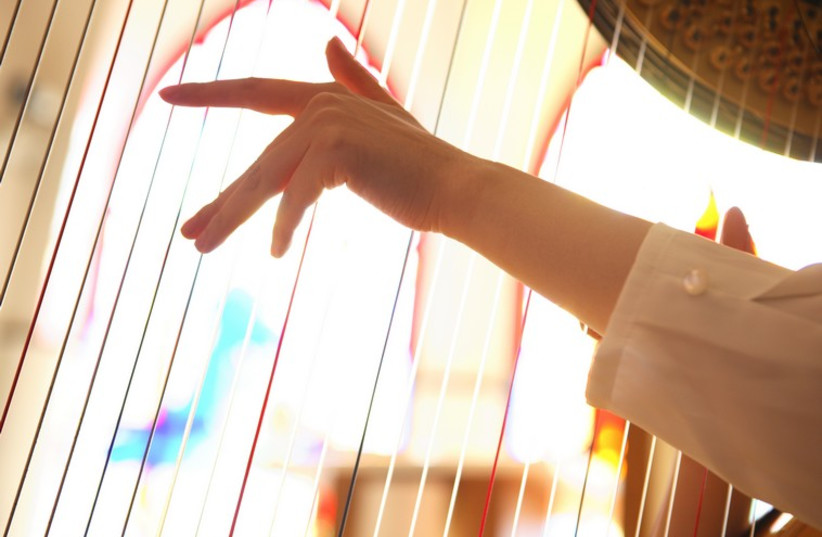 Woman playing a harp (illustrative) (photo credit: ING IMAGE/ASAP)