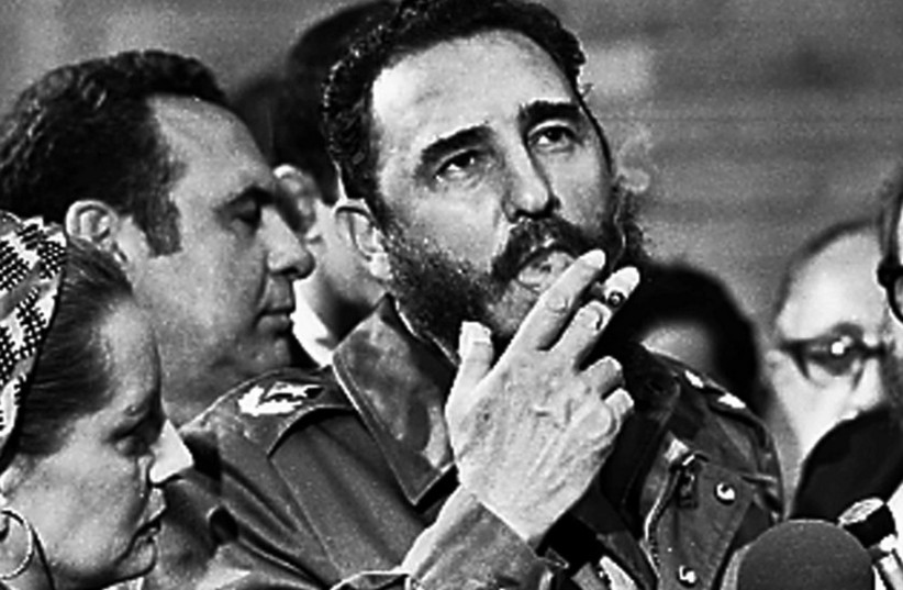 File picture of Fidel Castro smoking a cigar during interview with the press in Havana (photo credit: REUTERS)