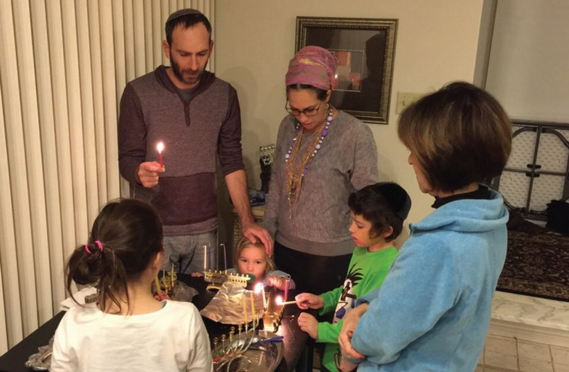 YAEL ECKSTEIN and her family lighting the Hanukka candles. (photo credit: Courtesy)