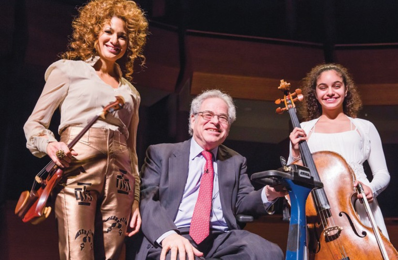 GRAMMY-AWARD winning violinists Miri Ben-Ari (far left) and Itzhak Perlman take part in the America Israel Cultural Foundation’s 75th anniversary concert in New York.  (photo credit: (AICF/CHRIS LEE))