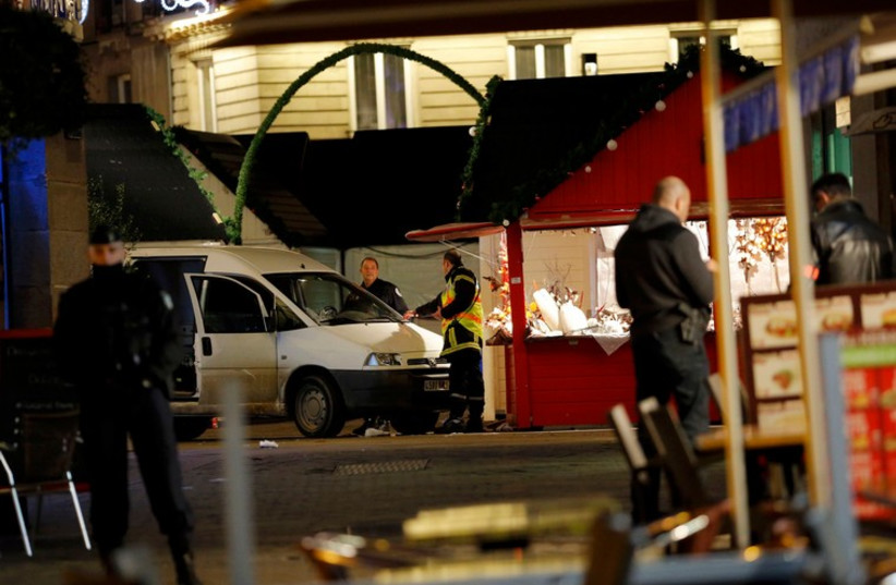 French police investigators work near a van which was driven into a crowd in Nantes December 22 (photo credit: REUTERS)