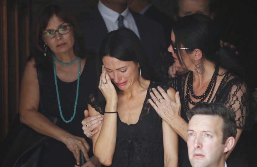 Mourners react as they leave the funeral of Sydney cafe siege victim, cafe manager Tori Johnson at St Stephens Uniting Church in Sydney (photo credit: REUTERS)