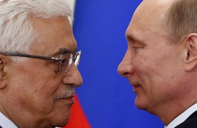 Russian President Vladimir Putin (R) and Palestinian Authority chief Mahmoud Abbas in Moscow (photo credit: REUTERS)