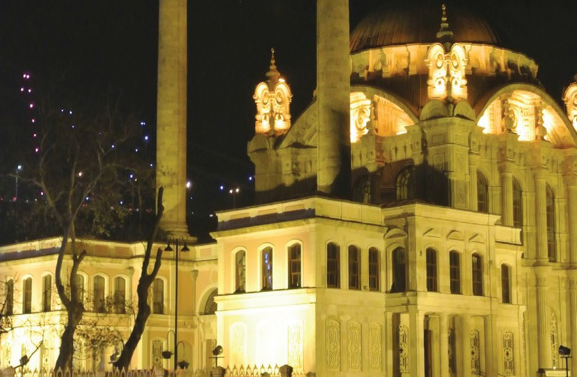 THE LIGHTS of the Ortaköy Mosque in Istanbul reflect off the Bosphorus (photo credit: SETH J. FRANTZMAN)