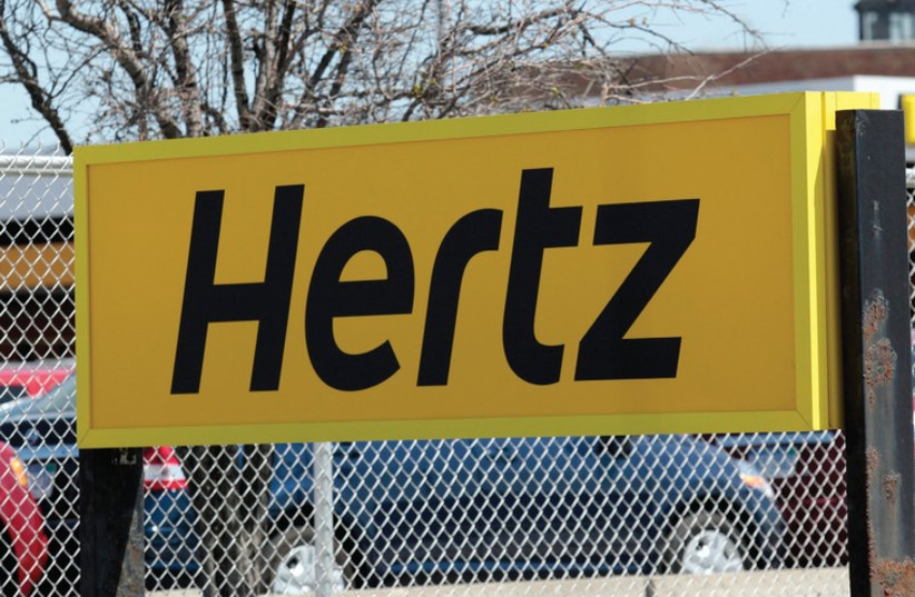 A HERTZ RENTAL car sign is placed outside a rental lot near Detroit Metropolitan airport in Romulus, Michigan (photo credit: REUTERS)