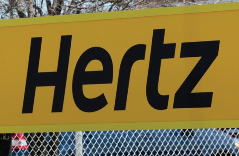 A HERTZ RENTAL car sign is placed outside a rental lot near Detroit Metropolitan airport in Romulus, Michigan (photo credit: REUTERS)