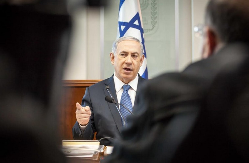 Prime Minister Benjamin Netanyahu addresses weekly cabinet meeting in Jerusalem, December 28, 2014 (photo credit: EMIL SALMAN/POOL)