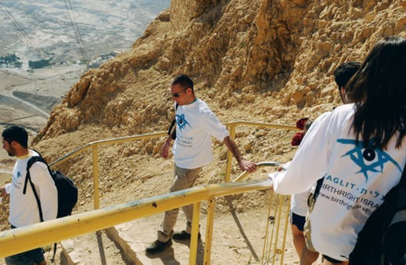 A TAGLIT-BIRTHRIGHT group climbs down the slope of Masada (photo credit: TAGLIT-BIRTHRIGHT)